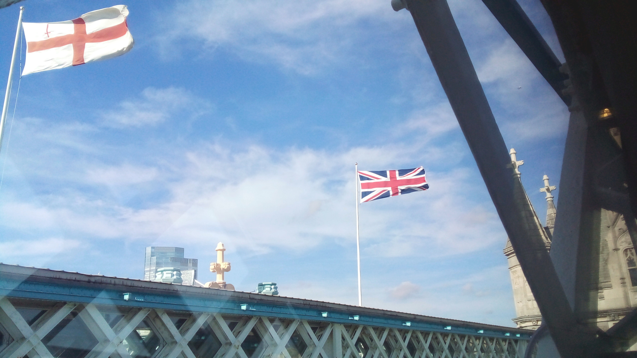The flag of the City of London and the Union Flag flying above the Tower Bridge.
